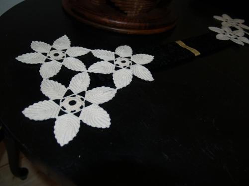 a black shirt with white flowers on a table at Pannonia Terranova in Vardarac