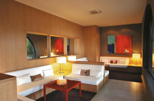 a living room with two beds and a table at Hotel El Castell in Sant Boi del Llobregat