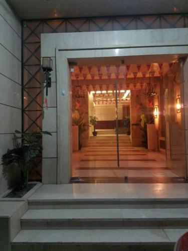 a lobby of a building with a door and stairs at Stanley Bridge Apartment in Alexandria