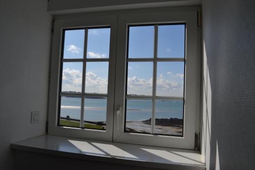 a window in a room with a view of the ocean at Hôtel La Porte Saint Pierre-Logis Hôtel Intra Muros in Saint Malo