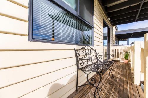 a bench on the front porch of a house at Alfies on Albert Daylesford in Daylesford