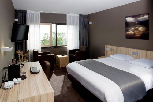 Postel nebo postele na pokoji v ubytování Fletcher Wellness-Hotel Stadspark
