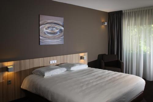 Postel nebo postele na pokoji v ubytování Fletcher Wellness-Hotel Stadspark