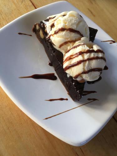 a piece of chocolate cake with ice cream on a plate at La Facha Hostal Restaurant Surf in Mompiche