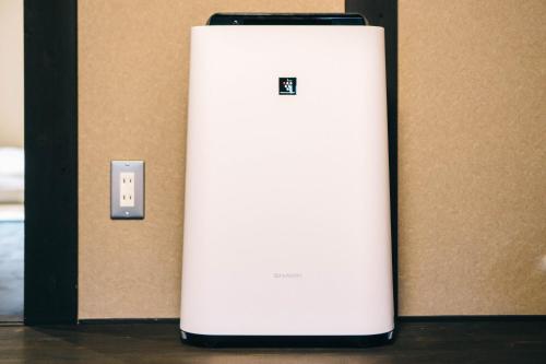 a white refrigerator next to a wall with an electrical outlet at Miro Saiinnishi Imadacho Tei in Kyoto