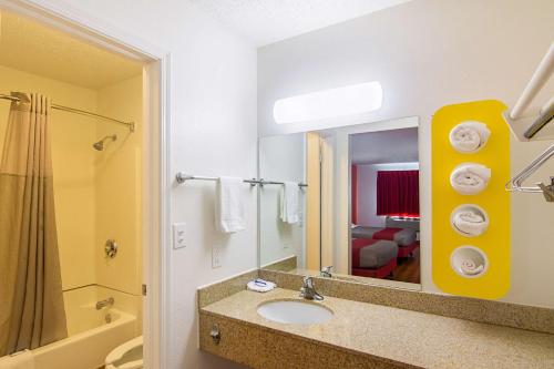 a bathroom with a sink and a mirror at Motel 6-Lawton, OK in Lawton