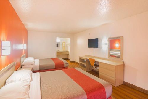 a hotel room with two beds and a desk at Motel 6-Lawton, OK in Lawton