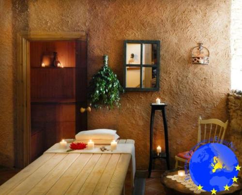 a room with a table with candles and a mirror at Pakruojis Manor Hotel Miller's house in Pakruojis