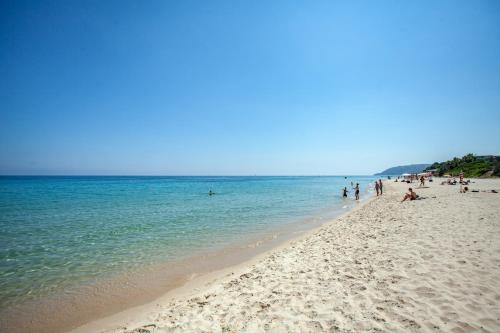 a group of people on a beach near the water at Villa Alma - S4199 in Santa Margherita di Pula