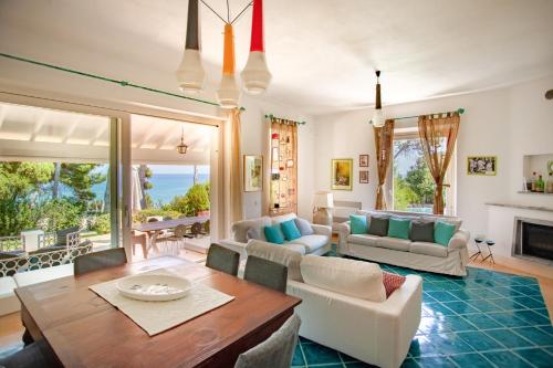 a large living room with a table and chairs at Villa Alma - S4199 in Santa Margherita di Pula