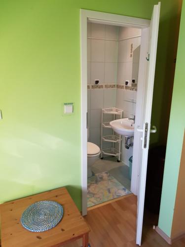 a bathroom with a toilet and a sink at Elexia in Sianozety