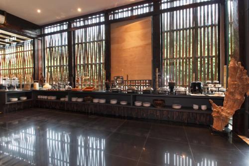 a room with windows and a counter with dishes at Bamboori Boutique Resort in Chiang Mai