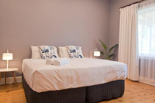 a bedroom with a bed with two towels on it at 29 Jane in Tanunda