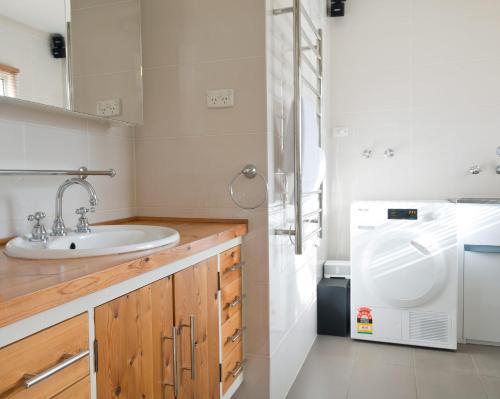 a bathroom with a sink and a refrigerator at 29 Jane in Tanunda