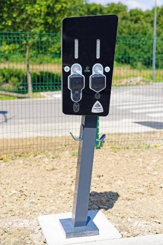 a parking meter on a stand in a park at Hôtel AKENA Besançon in Besançon