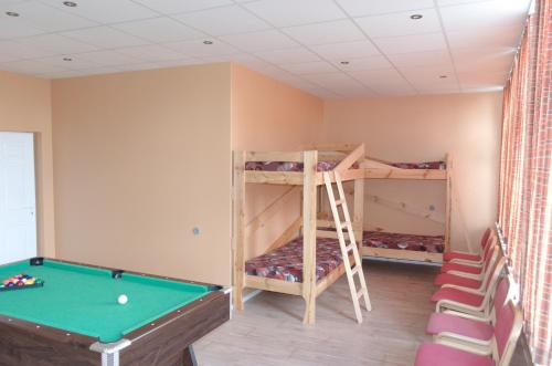 a room with bunk beds and a pool table at Nakvynė Miroslave in Alytus