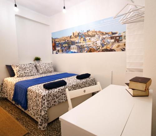 a bedroom with two beds and a painting on the wall at Cathedral Palace ALMERIA in Almería