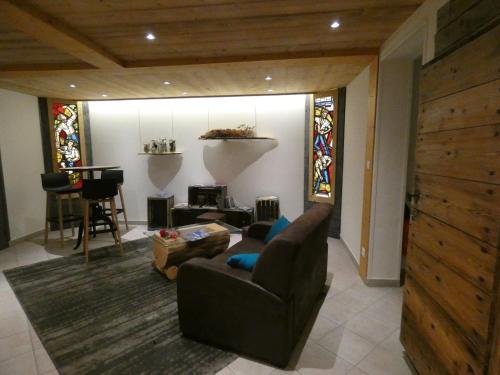 a living room with a couch and a table at Hôtel Du Midi in Thônes