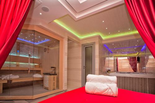 a room with red curtains and a chair in a room at Wellness & Spa Hotel ACD Annex in Herceg-Novi