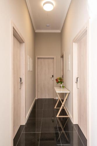 a hallway with doors and a table with flowers on it at Boutique B&B Villa Faggioni in Cavtat