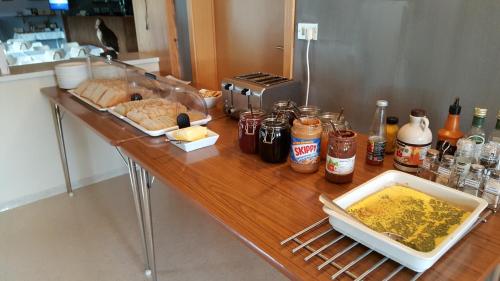 a wooden counter with food and condiments on it at Kidagil Guesthouse in Thingeyjarsveit