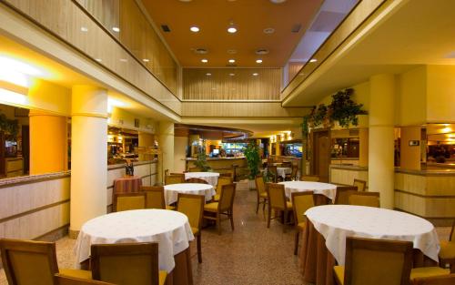 a dining room with white tables and chairs at Hotel San Antonio in Albacete