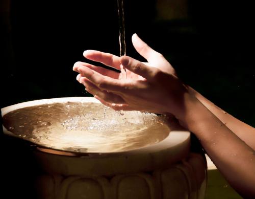 a person holding a bowl with a spoon in it at Bagni Di Pisa Palace & Thermal Spa - The Leading Hotels of the World in San Giuliano Terme