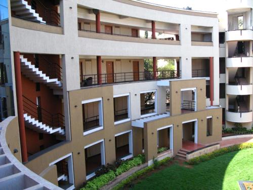 an external view of a building with balconies at Malligi,Hampi in Hospet