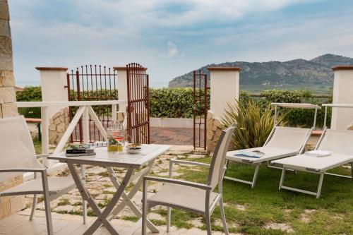 a table and chairs on a patio with a view at Hotel Residence Il Porto in Mattinata
