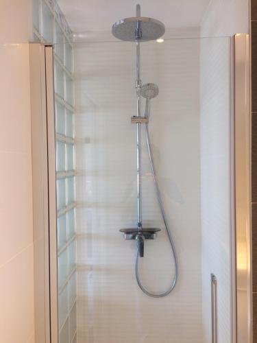 a shower in a bathroom with a shower head at Suite Sun And Sea in Alicante