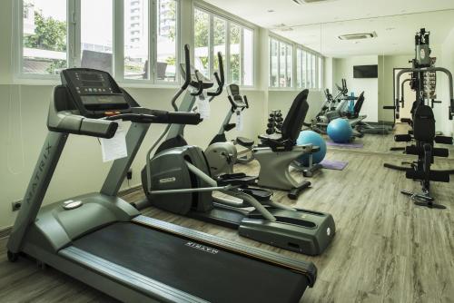 a gym with treadmills and elliptical machines at Le Tada Residence in Bangkok
