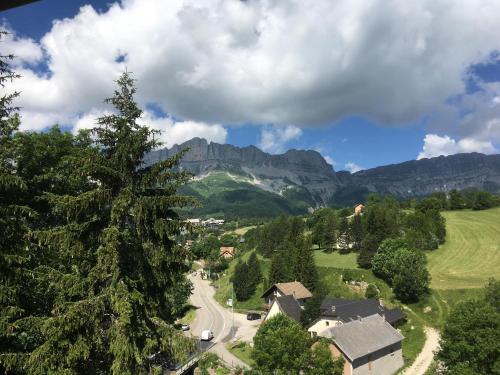 a village in the mountains with a tree at La Chicholiere in Gresse-en-Vercors