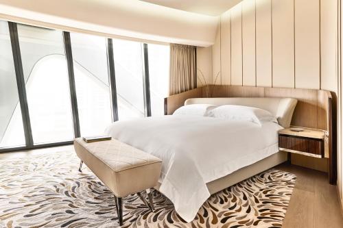 a bedroom with a large bed and a large window at City of Dreams - Morpheus in Macau