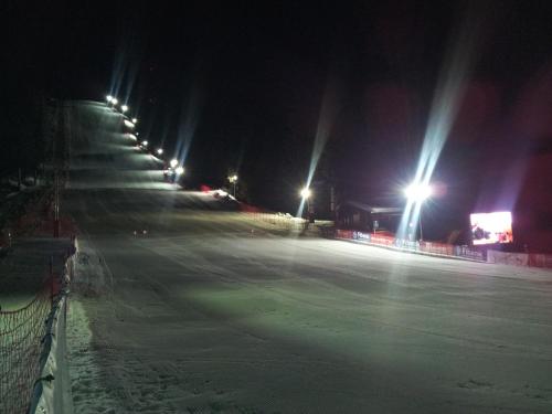 an empty ice hockey rink at night with lights at Hotel Iva & Elena in Pamporovo