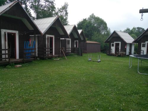 a group of houses in a yard with a ping pong table at Rekreacni stredisko u Kralicke chaty in Staré Město