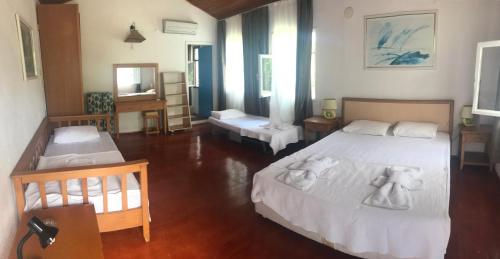 1 dormitorio con 2 camas y toallas. en Mila Pansiyon, en Cıralı