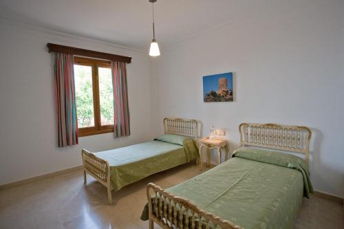 Postel nebo postele na pokoji v ubytování Villa Sa Coma