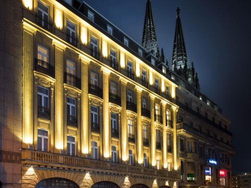 een groot gebouw met 's nachts verlichting bij Excelsior Hotel Ernst am Dom in Keulen