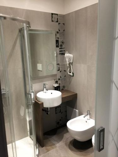 a bathroom with a sink and a toilet and a shower at B&B Bella Costa - lungomare Porto Cesareo in Porto Cesareo