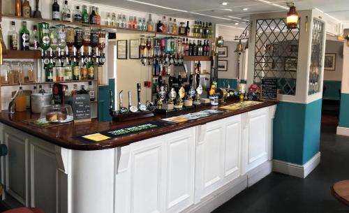 a bar in a pub with a lot of alcohol at The London Inn in Padstow