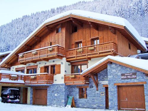 a large wooden building with a balcony on it at Chalet in Champagny en Vanoise with Vanoise summits in Le Villard