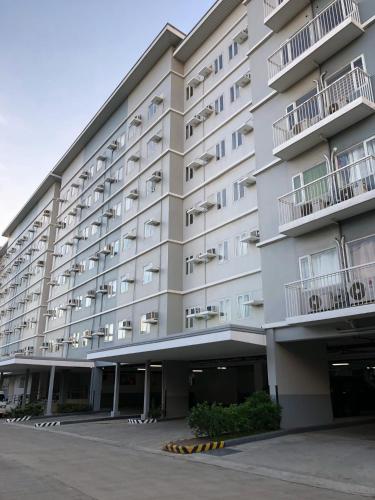 a large white building with windows and balconies at SMDC Trees Residences Tower 1 - 2BR Newly Renovated Staycation in Manila
