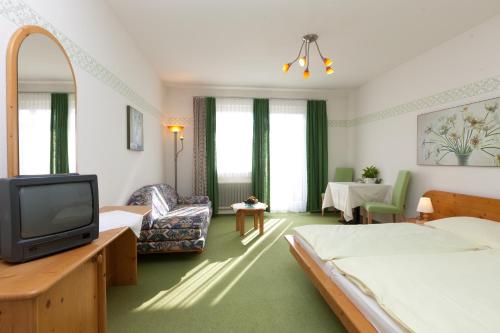 a hotel room with two beds and a tv at Weststeirischer Hof in Bad Gams