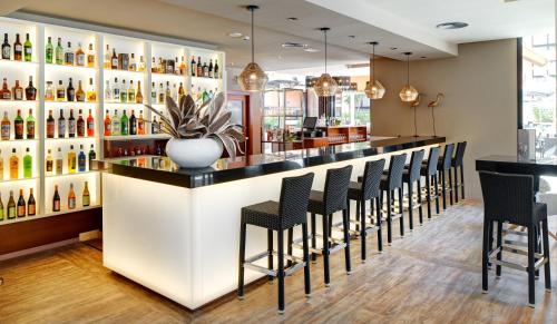 a bar in a restaurant with black stools at Protur Turo Pins 4* SUP in Cala Ratjada