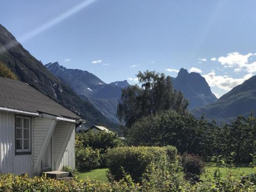 a house with a view of mountains in the background at Åndalsnes gustehouse in Åndalsnes