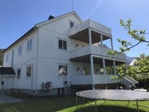 a white house with a ping pong table in front of it at Åndalsnes gustehouse in Åndalsnes