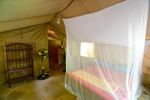 a bedroom with a bed in a tent at Stilts Diani Beach in Diani Beach
