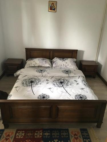 a bedroom with a bed with a white comforter at Wineyards Salin in Turda