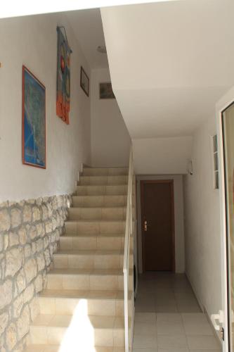 a staircase in a house with a stone wall at Villa Hortus in Neum