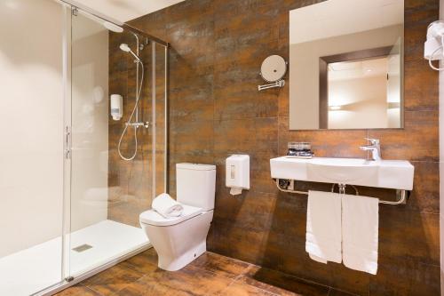 a bathroom with a toilet and a sink and a shower at Hotel Acta Azul Barcelona in Barcelona